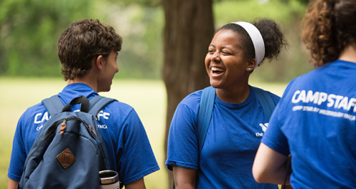 y camp counselors talking and smiling